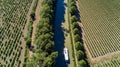 Aerial top view of boat in Canal du Midi from above, travel by barge in Southern France Royalty Free Stock Photo