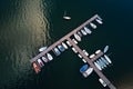 Aerial top view of boats near wooden pier at lake Royalty Free Stock Photo