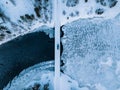 Aerial top view of bridge road above frozen river in snow winter Finland