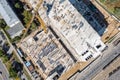 Aerial top view of busy construction site with working construction machinery