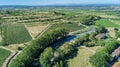 Aerial top view of Canal du Midi and vineyards from above, beautiful rural countryside landscape of France