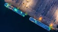 Aerial top view car carrier vessel at night, rows of new cars at night waiting to be dispatch and shipped import export new cars