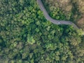 Aerial top view of car driving on highway road in the forest. Green trees and morning fog. Green trees background for carbon Royalty Free Stock Photo