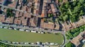 Aerial top view of Castelnaudary residential area houses roofs, streets and canal with boats from above, old medieval town Royalty Free Stock Photo