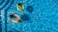 Aerial top view of children in swimming pool from above, happy kids swim on inflatable ring donuts and have fun in water Royalty Free Stock Photo