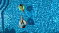 Aerial top view of children in swimming pool from above, happy kids swim on inflatable ring donuts and have fun in water Royalty Free Stock Photo