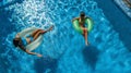 Aerial top view of children in swimming pool from above, happy kids swim on inflatable ring donuts in water on family Royalty Free Stock Photo