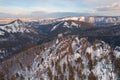 Aerial top view city Krasnoyarsk Russia taiga forest and rocks of stolby sanctuary, winter sunset