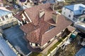 Aerial top view of complex house metal shingle roof and high brick chimneys. Roofing, construction, repair and renovation work