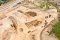 Aerial top view of construction site with excavator and dump trucks Royalty Free Stock Photo