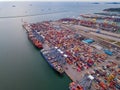 Aerial top view of container cargo ship in the export and import business and logistics international goods in urban city.