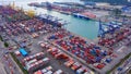 Aerial top view of container cargo ship in the export and import business and logistics international goods in urban city.