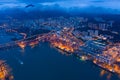 Aerial top view of container cargo ship in the export and import business and logistics international goods in urban city.