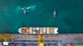 Aerial top view container ship at terminal seaport with tugboat, Global business cargo freight ship import export logistic and Royalty Free Stock Photo