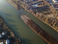 Aerial top view, countryside panorama of small island with dry grass in quiet river on sunny day. Drone photography Royalty Free Stock Photo