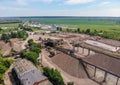 Aerial top view of crushing machinery, conveying crushed granite gravel stone in quarry open pit mining. Processing plant for