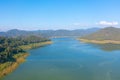 Aerial top view of a dam with forest trees, lake, river, mountain hills in travel and environment concept. Nature landscape Royalty Free Stock Photo