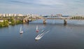 Aerial top view of Darnitsky bridge, yachts and boats sailing in Dnieper river from above, Kiev Kyiv city skyline Royalty Free Stock Photo