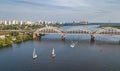 Aerial top view of Darnitsky bridge, yachts and boats sailing in Dnieper river from above, Kiev Kyiv city skyline Royalty Free Stock Photo