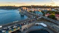 Aerial top view of Dnieper river and Podol district skyline from above, traffic jam on road, sunset in Kiev city, Ukraine