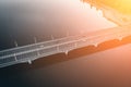 Aerial or top view from drone of concrete bridge with asphalt road or highway over big river with city car traffic Royalty Free Stock Photo