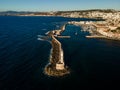 Aerial top view by drone of iconic Venetian lighthouse in the entrance of picturesque old port of Chania at sunset on Crete island Royalty Free Stock Photo