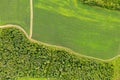 Aerial top view drone photography of a land with sown green fields in countryside Royalty Free Stock Photo