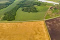 Aerial top view drone photography of a land with sown green fields in countryside Royalty Free Stock Photo