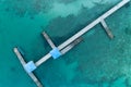 Aerial top view drone shot of long bridge in to the tropical sea Royalty Free Stock Photo