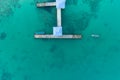 Aerial top view drone shot of long bridge in to the tropical sea Royalty Free Stock Photo