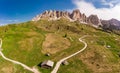Aerial top view from drone to wonderful alpine landscape and meadows at Pass Gardena with majestic Sella mountain group in Royalty Free Stock Photo