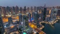 Aerial top view of Dubai Marina night to day timelapse. Modern towers and traffic on the road Royalty Free Stock Photo