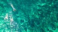 Aerial top view of family snorkeling from above, mother and kids snorkelers swimming in a clear tropical sea water, Thailand Royalty Free Stock Photo