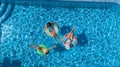 Aerial top view of family in swimming pool from above, happy mother and kids swim on inflatable ring donuts and have fun in water Royalty Free Stock Photo