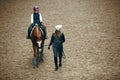 Aerial, top view. Female teacher, instructor teaching little girl, kid horseback riding. Careful ride, outdoor lesson Royalty Free Stock Photo