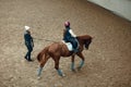 Aerial, top view. Female teacher, instructor teaching little girl, kid horseback riding. Education, animal sport Royalty Free Stock Photo