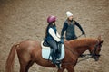 Aerial, top view. Female teacher, instructor teaching little girl, kid horseback riding. Outdoor lesson Royalty Free Stock Photo