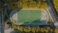 Aerial top view of football team practicing on a green soccer field. Video. Flying above an old sports stadium in a Royalty Free Stock Photo