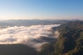 Aerial top view of forest trees and green mountain hills with sea fog, mist and clouds. Nature landscape background, Thailand Royalty Free Stock Photo