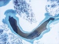 Aerial top view of frozen lake among snow winter landscape, abstract nature background Royalty Free Stock Photo