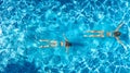 Aerial top view of girls in swimming pool water from above, active children swim, kids have fun on tropical family vacation Royalty Free Stock Photo