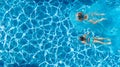 Aerial top view of girls in swimming pool water from above, active children swim, kids have fun on tropical family vacation Royalty Free Stock Photo