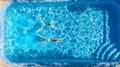 Aerial top view of girls in swimming pool water from above, active children swim, kids have fun on tropical family vacation Royalty Free Stock Photo