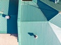 Aerial view of green corrugated metal house roof