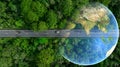 Aerial top view of green electric vehicle car driving over straight forest road, EV car electric vihicle car on forest road with