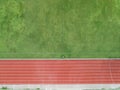 Aerial top view on Half of soccer field, football field with red running track. race track in a stadium. Royalty Free Stock Photo