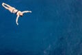 Aerial top view happy young woman in black swimsuit swims in the Red Sea, Egypt, Sharm el Sheikh. Vacation and adventure Royalty Free Stock Photo