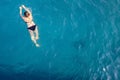 Aerial top view happy young woman in black swimsuit swims in the Red Sea, Egypt, Sharm el Sheikh. Vacation and adventure Royalty Free Stock Photo