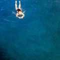 aerial top view happy young woman in black swimsuit swims in the Red Sea, Egypt, Sharm el Sheikh. Vacation and adventure Royalty Free Stock Photo