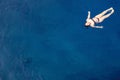 aerial top view happy young woman in black swimsuit swims in the Red Sea, Egypt, Sharm el Sheikh. Vacation and adventure Royalty Free Stock Photo